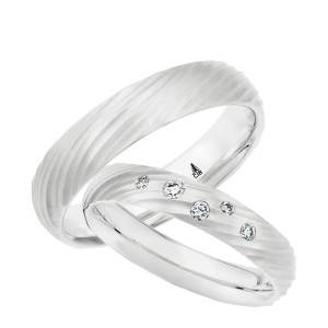 Christian Bauer 274793 14 karat white gold wedding band, angled view of a satin dome carved with diagonal fluted grooves that sweep across the face and scallop both edges, shown with its matching ring