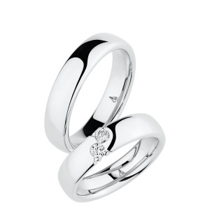 Christian Bauer 280103 18 karat white gold wedding band, angled view of a mirror polished softly domed face with a sharp edge break into the polished interior, shown with its matching ring