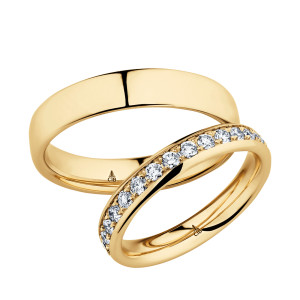 Christian Bauer 280145 18 karat yellow gold wedding band, angled view of a low polished dome with softly rounded edges and a mirror polished interior, shown with its matching ring