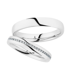 Christian Bauer 280193 14 karat white gold wedding band, angled view of a rounded polished dome, the bright surface running unbroken into a polished interior, shown with its matching ring