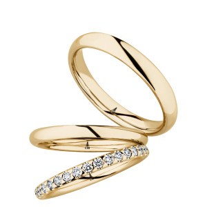 Christian Bauer 280227 14 karat yellow gold wedding band, angled view of a polished rounded profile with a soft edge break and a bright polished interior, shown with its matching rings