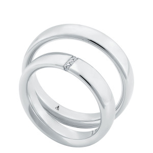Christian Bauer 280253 platinum wedding band, angled view of a flat polished face with softly rounded edges, the surface unbroken into a polished interior, shown with its matching ring