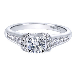 Gabriel & Co. ER910078W44JJ 14 karat white gold Contemporary engagement ring, front view of a round center clasped between pave rolls above graduated channel set shoulders