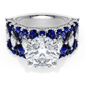 21RD10BS312W top view, round brilliant center stone on a wide white gold band of blue sapphires with marquise diamond accents