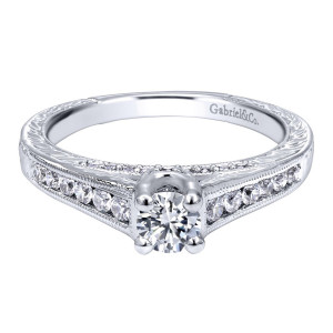 Gabriel & Co. ER910176W44JJ 14 karat white gold Contemporary engagement ring, front view of the four prong center above channel set rows edged with milgrain