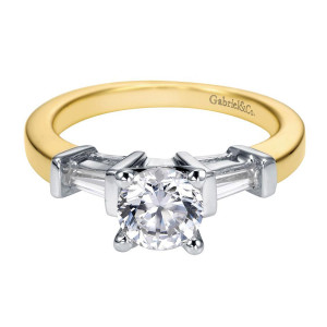 Gabriel & Co. ER2792M43JJ two-tone 14 karat gold Contemporary engagement ring, front view of a round center in four prongs with a tapered baguette bar set each side