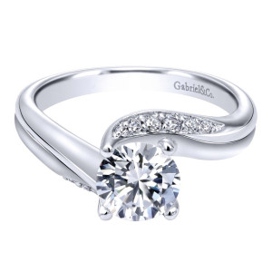 Gabriel & Co. ER10764W44JJ 14 karat white gold Contemporary engagement ring, front view of the round center with a curved row of small stones along one arm