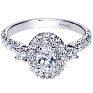 Gabriel & Co. ER9005W44JJ 14 karat white gold Contemporary engagement ring, front view of the oval center in a single halo flanked by round side stones