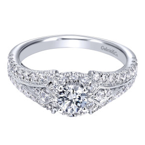 Gabriel & Co. ER910140W44JJ 14 karat white gold Contemporary engagement ring, angled view of the round center in a low halo above milgrain edged pave rows