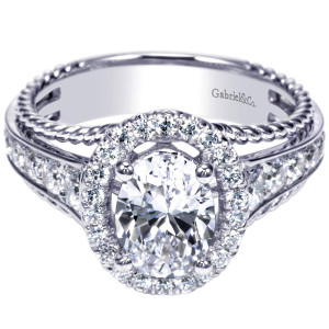 Gabriel & Co. ER8807W44JJ 14 karat white gold Contemporary engagement ring, angled view of the oval center in a single halo between rope edged pave shoulders