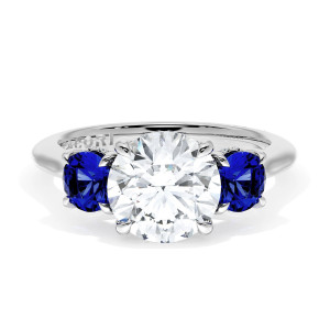 41027RD8BS Platinum top view, round brilliant center flanked by round blue sapphires on a polished white metal band