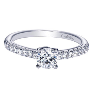 Gabriel & Co. ER98565W44JJ 14 karat white gold Contemporary engagement ring, front view of the round center lifted above one pave row on a slim straight shank