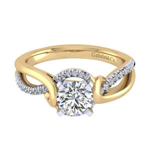 Gabriel & Co. ER7801M44JJ two-tone 14 karat gold Contemporary engagement ring, front view of the round center where a plain arm crosses a pave set arm