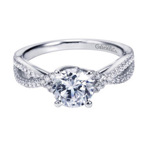 Gabriel & Co. ER7546W44JJ 14 karat white gold Contemporary engagement ring, angled view of the round center above crossing pave rails that weave across the shoulders