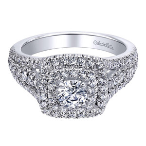 Gabriel & Co. ER910094W44JJ 14 karat white gold Contemporary engagement ring, top view of a small round center ringed by two halo rows, shoulders massed with pave