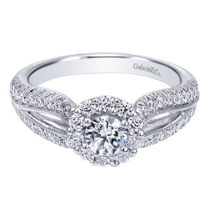 Gabriel & Co. ER910150W44JJ 14 karat white gold Contemporary engagement ring, angled view of the round center in a halo of larger stones above split pave rails