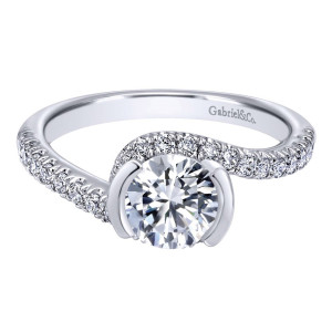 Gabriel & Co. ER10472W44JJ 14 karat white gold Contemporary engagement ring, front view of a round center gripped by two curved rails inside a pave swirl