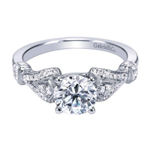 Gabriel & Co. ER7531W44JJ 14 karat white gold Victorian engagement ring, front view of the round center between milgrain edged pave ribbons crossing over pierced shoulders