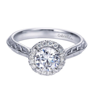 Gabriel & Co. ER7829W44JJ 14 karat white gold Victorian engagement ring, angled view of the round center in a single halo above hand engraved shoulders