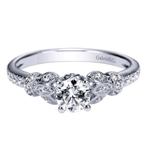 Gabriel & Co. ER98684W44JJ 14 karat white gold Victorian engagement ring, front view of a round center between leafy milgrain motifs set with tiny bright stones