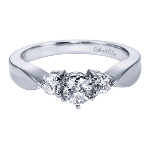 Gabriel & Co. ER1705PT3JJ platinum Contemporary engagement ring, angled view of a round center flanked by two rounds above broad pinched shoulders