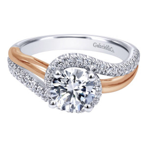Gabriel & Co. ER10308T44JJ two-tone 14 karat gold Contemporary engagement ring, angled view of the round center held by four prongs above crossing pave and polished arms
