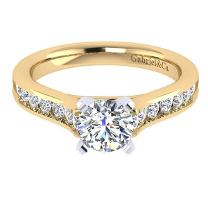 Gabriel & Co. ER7438M44JJ two-tone 14 karat gold Contemporary engagement ring, front view of the round center in four squared prongs above channel set tapering shoulders