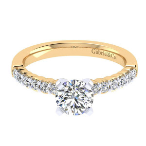 Gabriel & Co. ER6874M44JJ two-tone 14 karat gold Contemporary engagement ring, top view of the shared prong stone row running down each shoulder toward a flat shank