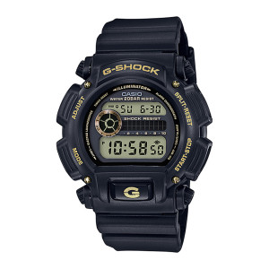 Casio G-Shock DW9052GBX-1A9 watch, front view of a matte black case with gold tone lettering, screws and two stacked display windows