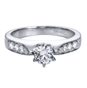 Gabriel & Co. ER1702PT3JJ platinum Contemporary engagement ring, angled view of the round center set low between wide shoulder panels of bead set rounds