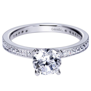 Gabriel & Co. ER94121W44JJ 14 karat white gold Victorian engagement ring, angled view of an even shoulder row edged with milgrain along a flat straight shank
