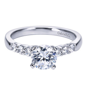Gabriel & Co. ER7850W44JJ 14 karat white gold Contemporary engagement ring, front view of the round center in four prongs with graduated shared prong stones alongside