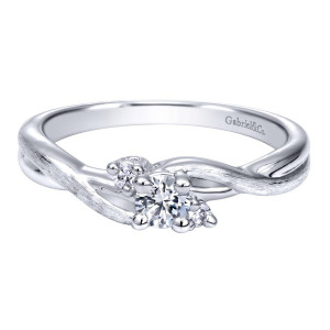 Gabriel & Co. ER910077W44JJ 14 karat white gold Contemporary engagement ring, front view of a small round center between two tiny accents on crossing brushed rails