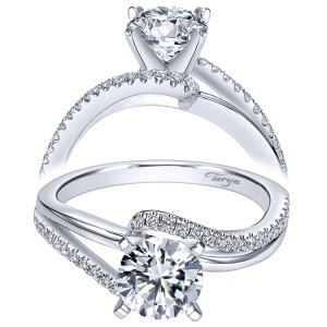 Taryn TE6974W44JJ 14 karat white gold engagement ring, angled view of a four prong round center with a pave rail sweeping across a smooth rail