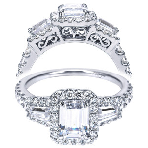 Taryn TE7269W44JJ 14 karat white gold engagement ring, front view of an emerald cut center in a halo between tapered baguettes with scrolled gallery