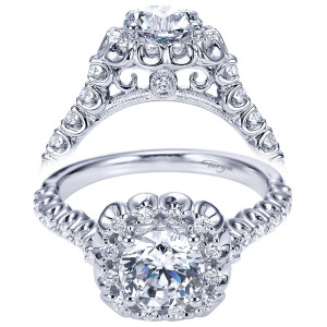 Taryn TE7488W44JJ 14 karat white gold engagement ring, front view of a round center in a halo ringed by pierced looped arches and scrolled gallery