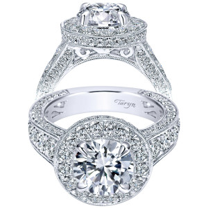 Taryn TE8301W83JJ 18 karat white gold engagement ring, front view of a round center in a milgrain halo raised on a filigree gallery above paved shoulders