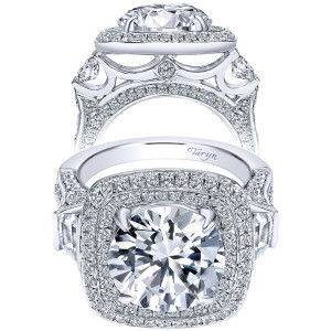 Taryn TE8310W83JJ 18 karat white gold engagement ring, front view of a round center in a double cushion halo between two trapezoid stones, pierced gallery