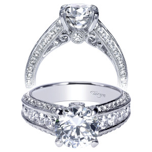 Taryn TE8747W44JJ 14 karat white gold engagement ring, front and profile views of a round center over a channel row flanked by milgrain edged pave rails