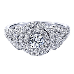 Gabriel & Co. ER910145W44JJ 14 karat white gold Contemporary engagement ring, angled view of the round center inside two concentric halo rows over broad pave shoulders