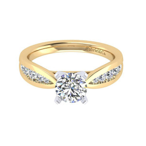 Gabriel & Co. ER8188M44JJ two-tone 14 karat gold Contemporary engagement ring, front view of the round center with channel stones set into a pinched tapering shoulder