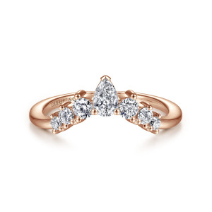 Gabriel & Co. AN15303K44JJ 14 karat rose gold Starlight anniversary band, front view of the pointed peak with a pear-shaped diamond and round stones stepping down each side
