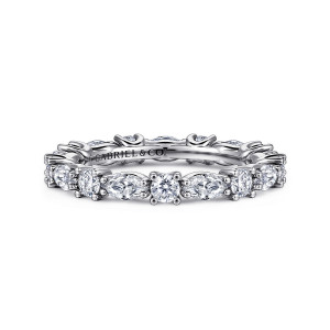 Gabriel & Co. AN15568-4W44JJ 14 karat white gold Classic eternity band, front view of four pronged round diamonds between tapered stones lying sideways