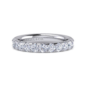 Gabriel & Co. AN15889-4W44JJ 14 karat white gold Classic eternity band, front view of round diamonds in a single line between pointed prongs on a polished hoop
