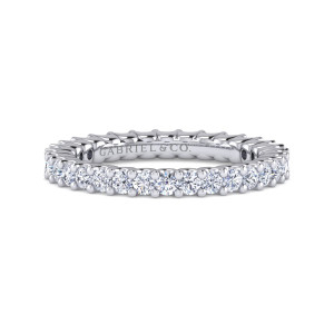 Gabriel & Co. AN15910-4W44JJ 14 karat white gold Classic eternity band, front view of round diamonds with small prongs rising between them along both edges