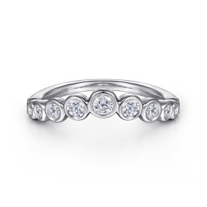 Gabriel & Co. AN16731W44JJ 14 karat white gold Contemporary anniversary band, front view of rimmed round stones stepping down in size from the middle along an arched top edge