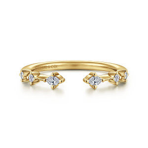 Gabriel & Co. AN16803Y44JJ 14 karat yellow gold Contemporary anniversary band, front view of the gap between two marquise diamonds with smaller round stones trailing behind each