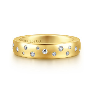Gabriel & Co. AN16876Y44JJ 14 karat yellow gold Contemporary cigar band, front view of scattered round diamonds of mixed sizes across a smooth domed band