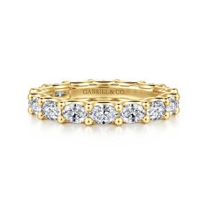 Gabriel & Co. AN17149-6Y44JJ 14 karat yellow gold Contemporary eternity band, front view of sideways elongated stones with small beads between them along the top of the band