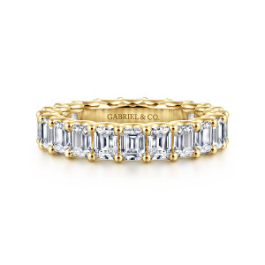 Gabriel & Co. AN17153-6Y43JJ 14 karat yellow gold Contemporary eternity band, front view of rectangular step cut diamonds held by round tipped prongs, with a maker's mark inside